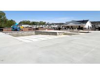 Community pool under construction with an adjacent playground and neighborhood homes in the background at 195 Anise Ln, Garner, NC 27529