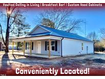 Newly constructed home with gray siding, covered porch, and convenient location at 2 Jenkins St, Erwin, NC 28334