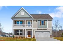 Charming two-story home with a welcoming front porch and attached two-car garage at 2820 Lacy Holt Rd, Graham, NC 27253