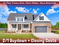 Brick home with gray garage door and front porch at 46 Otter Hole Dr, Kenly, NC 27542