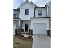 Charming townhome with attached garage, neutral siding, and inviting entryway at 1345 Bessie Ct, Wake Forest, NC 27587