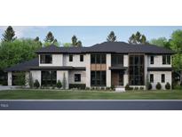 Striking modern home featuring stone and cement exterior with black framed windows at 4908 Foxridge Dr, Raleigh, NC 27614