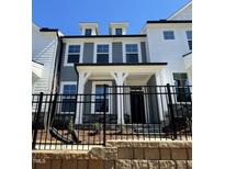 Charming townhome with gray and white siding, a welcoming front porch, and a black iron fence at 484 Traditions Grande Blvd # 29, Wake Forest, NC 27587