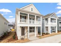 Charming two-story home featuring a welcoming front porch and classic architectural details at 9237 Kitchin Farms Way # 429, Wake Forest, NC 27587
