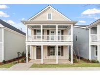 Charming two-story home featuring a welcoming double porch and neutral siding at 9237 Kitchin Farms Way # 429, Wake Forest, NC 27587
