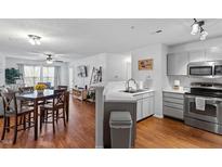 Modern kitchen features stainless steel appliances and open dining area with hardwood style floors at 129 Sturbridge Dr # 15, Clayton, NC 27520