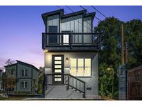 Modern two-story home boasts a balcony, clean lines, and a stylish gray brick facade at 2401 E Main St, Durham, NC 27703