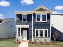 Charming two-story home with blue siding, stone accents, and a well-manicured lawn at 753 Portland Rose Dr, Knightdale, NC 27545