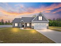 Beautiful home exterior with manicured lawn and modern gray color at 167 Thistle Ct, Sanford, NC 27332