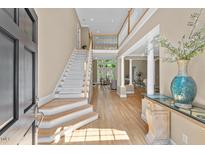 Elegant foyer with hardwood floors, staircase, and a view of the living room at 81504 Alexander, Chapel Hill, NC 27517