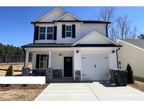 Charming two-story home with a white exterior, black accents, and a well-manicured front lawn at 17 S Mistflower St, Clayton, NC 27520