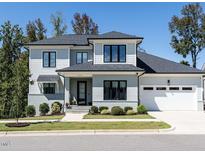 Beautiful two-story home with a well-manicured lawn, modern windows, and a gray brick facade at 123 Cottage Way, Pittsboro, NC 27312