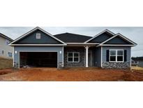 New construction home featuring blue siding, a two-car garage, stone accents and an inviting front entrance at 28 Decatur Dr, Fuquay Varina, NC 27526