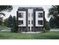 Modern townhome featuring sleek lines, large windows, and a beautifully landscaped front yard at 512 Gordon St # 1102, Durham, NC 27701