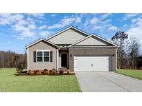 Brick and siding exterior of charming one-story home with two-car garage at 15 Back Country Ct, Youngsville, NC 27596