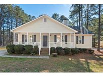Charming single-story home featuring a welcoming front porch and landscaped front yard at 5336 Covington Cross Dr, Knightdale, NC 27545