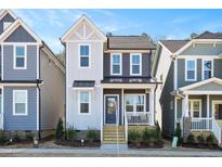 Two-story home with gray and white siding, a front porch, and landscaping at 146 Weavers Grove Dr, Chapel Hill, NC 27514