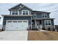 Two-story home with gray siding, white trim, and a three-car garage at 499 Glenkirk Pl # 101, Garner, NC 27529