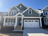 Two-story house with green siding, white trim, and a two-car garage at 1209 Porters Call Dr # 2260, Wendell, NC 27591