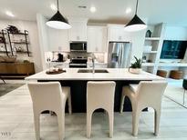 Bright kitchen features a spacious island with counter seating, stainless steel appliances and modern pendant lighting at 2117 Opulent Oaks Ln # 15, Durham, NC 27713