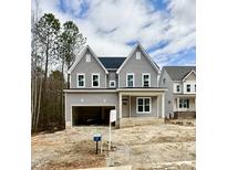 Charming two-story home featuring a spacious garage and inviting front porch at 2613 Silver Gate Ct, Wake Forest, NC 27587