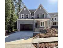 Two-story home featuring gray siding, white trim, a covered porch, and an attached two-car garage at 2613 Silver Gate Ct, Wake Forest, NC 27587