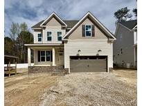 Charming two-story home features a neutral palette, brick accents, and a two-car garage at 2617 Silver Gate Ct, Wake Forest, NC 27587
