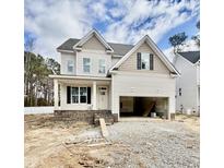 Charming two-story home with covered porch and unfinished two car garage at 2617 Silver Gate Ct, Wake Forest, NC 27587