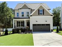 Charming two-story home featuring a well-manicured lawn and attached two-car garage at 2617 Silver Gate Ct, Wake Forest, NC 27587