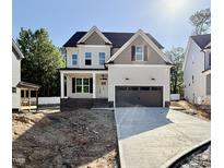 Charming two-story home with a two-car garage and inviting front porch on a sunny day at 2617 Silver Gate Ct, Wake Forest, NC 27587