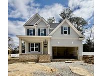 Newly constructed two-story home featuring gray siding, dark shutters, and an attached two-car garage at 2621 Silver Gate Ct, Wake Forest, NC 27587