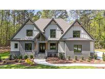 Charming gray home featuring a mixed material facade and professionally landscaped front yard at 330 Hidden Lake Dr, Youngsville, NC 27596
