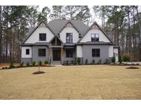A charming two-story home with mixed siding, gray accents, and a well-manicured lawn at 330 Hidden Lake Dr, Youngsville, NC 27596