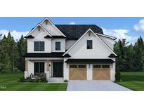 Beautiful two-story home featuring a two-car garage, black roof, black trim, and a landscaped front yard at 206 E Whitaker Mill Rd, Raleigh, NC 27608