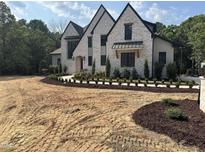 An exterior elevation view shows a landscaped front yard with fresh mulch and a white brick home at 65 Firefly Overlook, Pittsboro, NC 27312