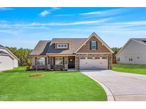 Charming single-Gathering home with a manicured lawn, stone accents, and a two-car garage at 258 Thistle Ct, Sanford, NC 27332