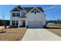 Beautiful two-story home with a classic white exterior and well-manicured lawn at 120 Wild Turkey Way, Lillington, NC 27546