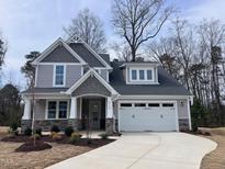 Charming two-story home with stone accents, neutral siding, attached two car garage and landscaped yard at 3113 Petrea Ct # 38, Angier, NC 27501