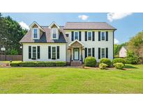Charming two-story home featuring a manicured lawn, dormer windows, and black shutter accents at 135 Deep Creek, Rougemont, NC 27572