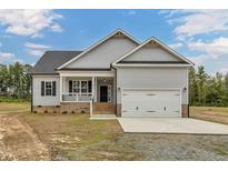 Gray siding one-story house with a two-car garage and front porch at 1516 Nc 55, Coats, NC 27521