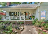 Inviting front porch with white railing and charming curb appeal, perfect for relaxing at 3608 White St, Sanford, NC 27332