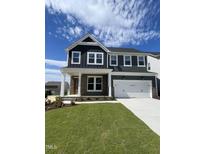 Beautiful two-story home with a stone and siding exterior, well-manicured lawn, and attached two-car garage at 321 Murray Grey Ln, Wake Forest, NC 27587