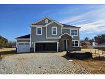 Two-story house with gray siding, stone accents, and a two-car garage at 7420 Prato Ct, Wendell, NC 27591