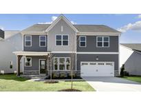 Charming two-story home with a gray facade, well-manicured lawn, and a two-car garage at 1301 Jasmine View Way, Knightdale, NC 27545