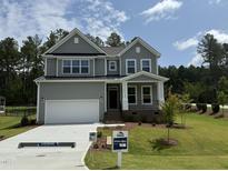 Charming two-story home with a well-manicured lawn, covered porch and a two-car garage at 135 Green Haven Blvd # 1, Youngsville, NC 27596