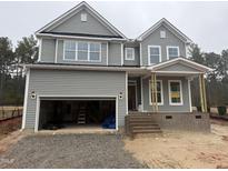 Two-story home showcasing a gray exterior, inviting front porch, and a convenient two-car garage at 135 Green Haven Blvd # 1, Youngsville, NC 27596