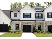 Charming townhome with white siding, black shutters, stone accents, and well-manicured lawn at 727 Putney Hill Rd, Zebulon, NC 27597