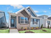 Charming two-story home with blue siding, brick accents, and a well-manicured front yard at 1304 Jasmine View Way, Knightdale, NC 27545