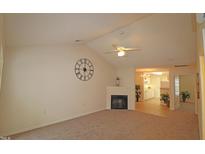 Bright living room featuring a fireplace, vaulted ceiling and ceiling fan at 11370 Clubhaven Pl # 103, Raleigh, NC 27617