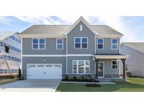 Charming two-story home with gray siding, white trim, and a well-manicured front yard at 524 Lemon Daisy Ln, Knightdale, NC 27545